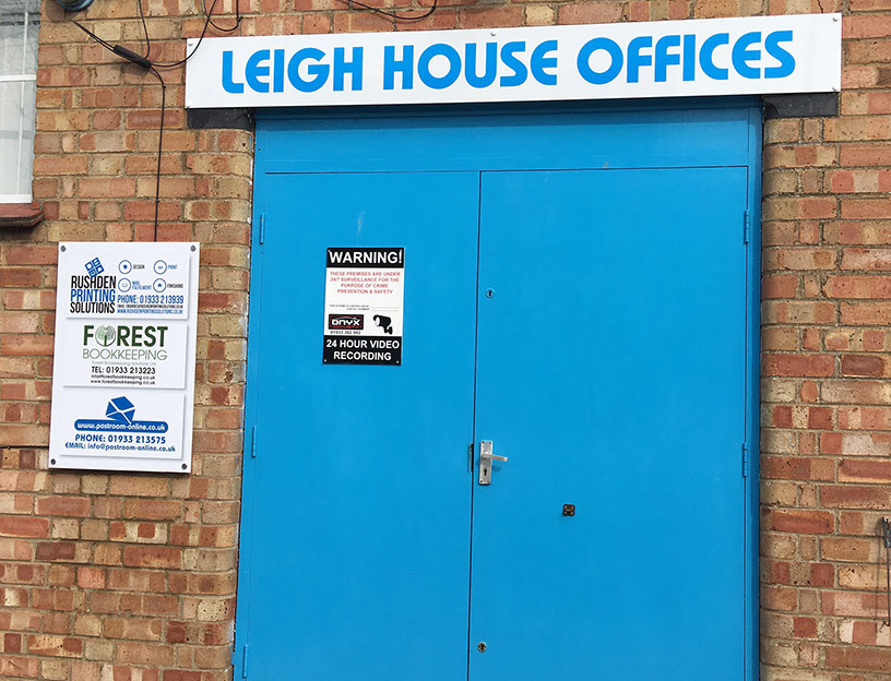 Doorway showing overhead sign and one to the left supplied and installed by Luxe Graphics, Desborough Sign company